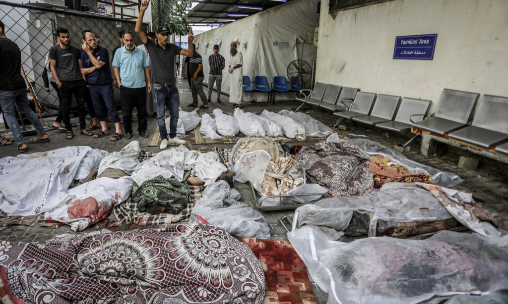 Palestinians wait to receive the bodies of their relatives who were killed in an Israeli airstrike, at Al-Najjar Hospital in Rafah, southern Gaza Strip, October 24, 2023. (Abed Rahim Khatib:Flash90)